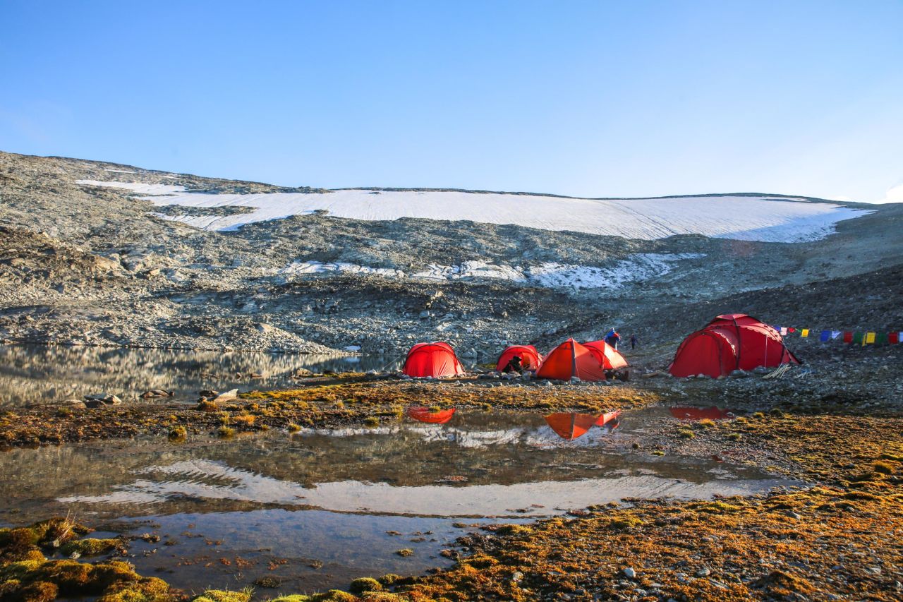 Some sites are so large that the archaeologists have to survey them for weeks to collect all the finds. In such cases, a base camp is established near the site, like this camp below the ice patch at 1,650 meters. 