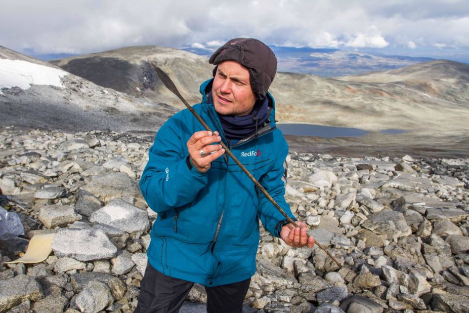 In Norway, archaeologists from a program called Secrets of the Ice are searching for items that melt out of ice patches. Pictured, a team member holds a 1,400-year-old arrow. 
