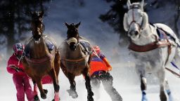 Competitors take part in the Skikjoering race at the White Turf horse racing event held on the frozen lake of the Swiss mountain resort of St. Moritz on February 17, 2019. - More images can be found on www.afpforum.com. Search slug: HORSE-RACING-SWITZERLAND (Photo by STEFAN WERMUTH / AFP)        (Photo credit should read STEFAN WERMUTH/AFP/Getty Images)