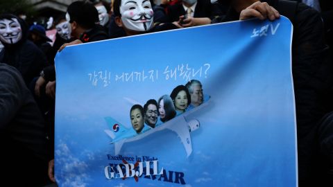 Korean Air pilots, cabin crew and activists, many wearing Guy Fawkes masks, attend a rally on May 4, 2018 in Seoul, South Korea.