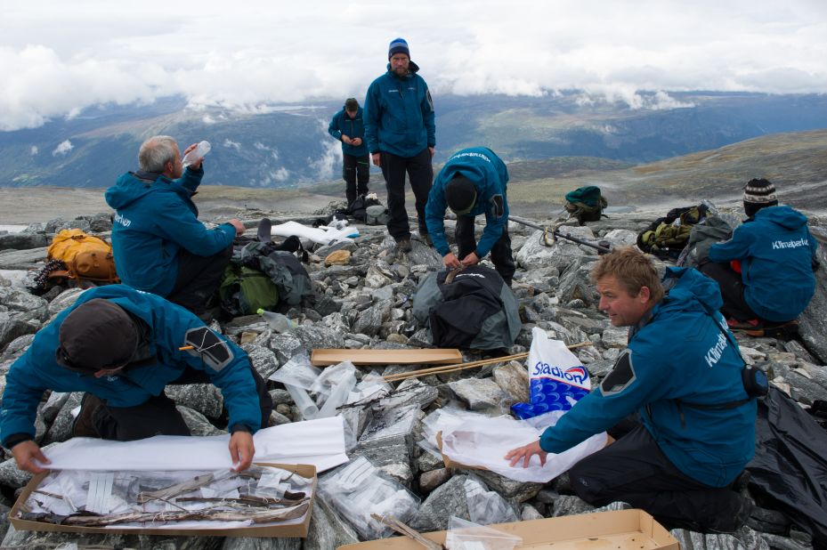 Glacial archaeologists pack artifacts after a day of fieldwork in a glaciated mountain pass.