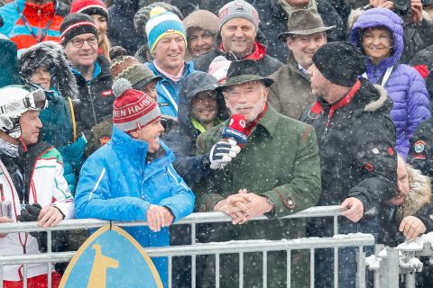 "He's back...!" Muscleman, movie star and politician Arnold Schwarzenegger takes in the action during his regular visit to the Hahnenkamm races in Kitzbuhel.