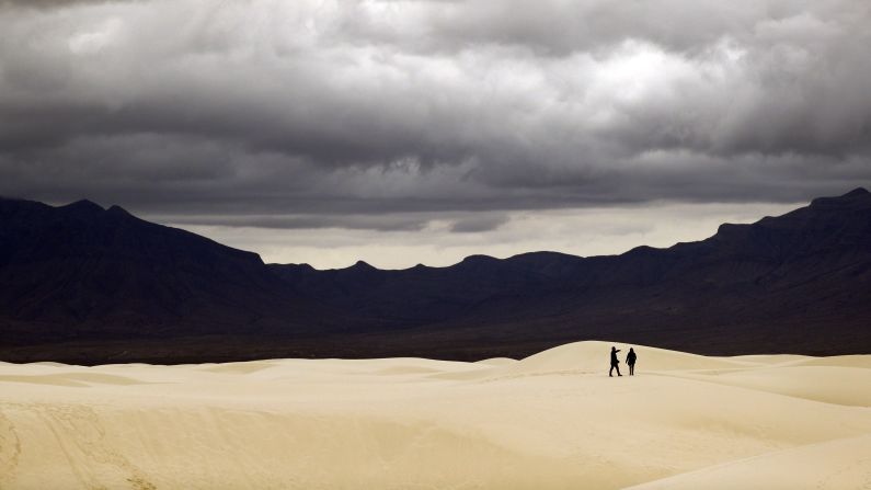 <strong>Otero County, New Mexico: </strong>Visitors walk across the dunes at the White Sands National Monument, which has reopened after being closed for 35 days due to the US government shutdown.