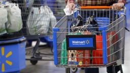 A customer pushes a shopping cart after at a Walmart Inc. store in Burbank, California, U.S., on Monday, Nov. 19, 2018. 