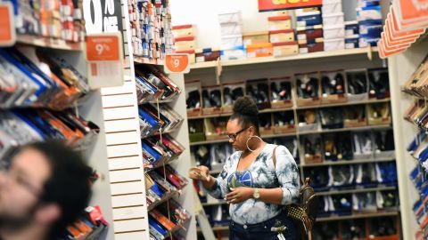 A woman shops at a Payless ShoeSource store in Orlando, Florida on February 17, 2019, the first day of the firm's liquidation sale after confirming on February 15, 2019 that it will close its 2,100 stores in the U.S. and Puerto Rico. 