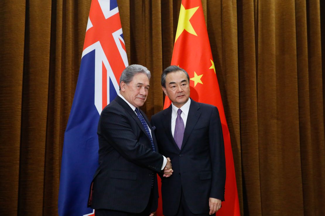 China's Foreign Minister Wang Yi (right) and New Zealand's Foreign Minister Winston Peters shake hands in Beijing on May 25, 2018. Tensions have grown between Auckland and Beijing in recent months. 