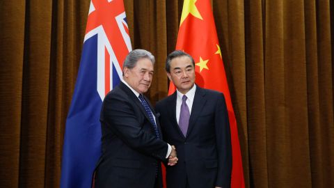 China's Foreign Minister Wang Yi (right) and New Zealand's Foreign Minister Winston Peters shake hands in Beijing on May 25, 2018. Tensions have grown between Auckland and Beijing in recent months.