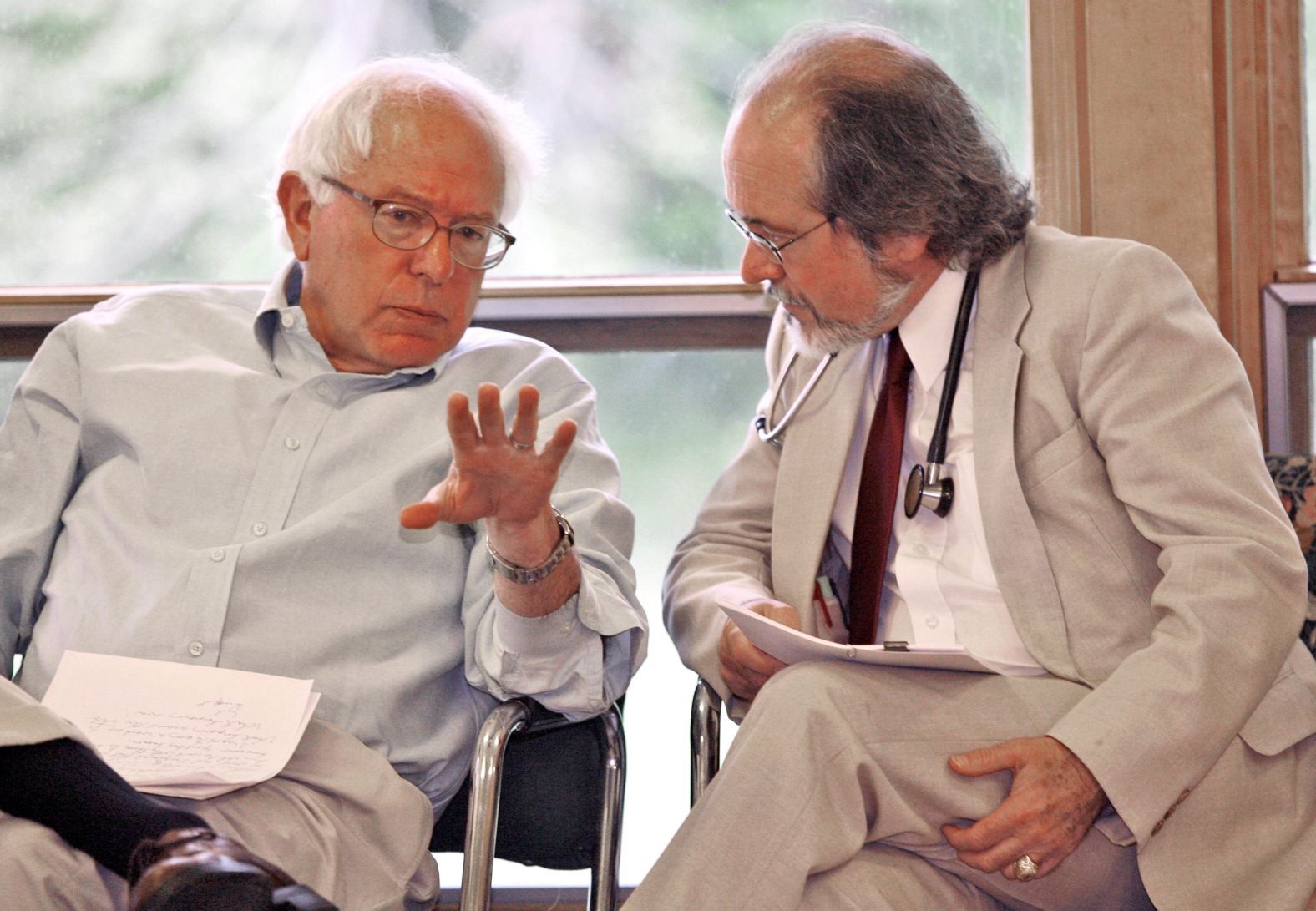 Sanders chats with Dr. John Matthew, director of The Health Center in Plainfield, Vermont, in May 2007. Sanders was in Plainfield to celebrate a new source of federal funding for The Health Center.