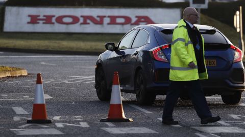 A man walks past the entrance of the Honda plant in Swindon on Tuesday.
