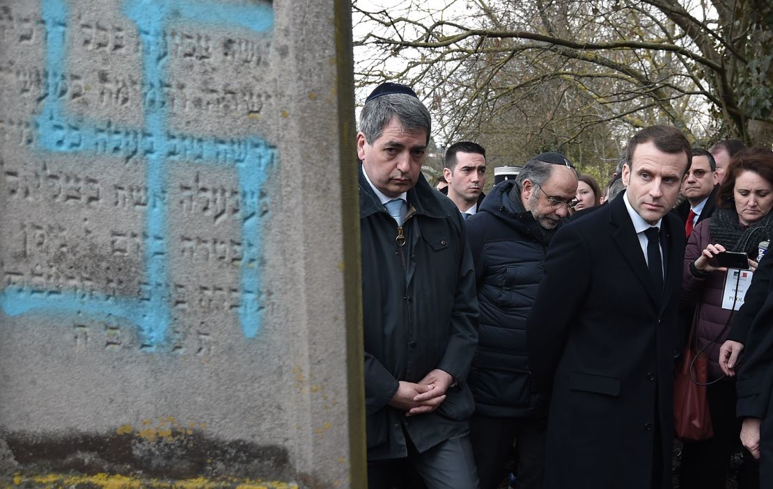 French President Emmanuel Macron at the Jewish cemetery in Quatzenheim, which was vandalized with Nazi symbols and other graffiti.