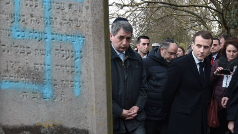 French President Emmanuel Macron at the Jewish cemetery in Quatzenheim, which was vandalized with Nazi symbols and other graffiti.