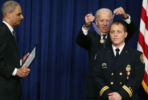 Biden awards the Medal of Valor to William Reynolds, a battalion chief with the Virginia Beach Fire Department, during a ceremony in Washington, DC, in February 2013. Biden presented the award to public safety officers who had exhibited exceptional courage, regardless of personal safety, in the attempt to save or protect others from harm.
