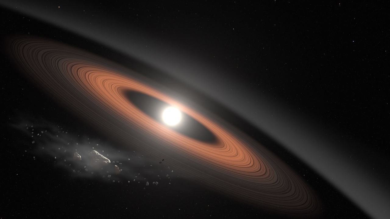 In this illustration, an asteroid (bottom left) breaks apart under the powerful gravity of LSPM J0207+3331, the oldest, coldest white dwarf known to be surrounded by a ring of dusty debris. Scientists think the system's infrared signal is best explained by two distinct rings composed of dust supplied by crumbling asteroids.