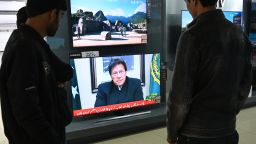 Pakistani people watch the television in Islamabad on February 19 as Prime Minister Imran Khan speaks to the population about the attack in Indian-administered Kashmir on February 14.