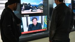 Pakistani people watch the television as Prime Minister Imran Khan speaks to the population about the suicide bombing in Indian-administered Kashmir that happened on February 14, in Islamabad on February 19, 2019. - Pakistan is ready to help India investigate the deadliest attack in Kashmir in decades, but will retaliate if Delhi attacks, Prime Minister Imran Khan said on February 19 as tensions between the nuclear-armed rivals soared. (Photo by AAMIR QURESHI / AFP)        (Photo credit should read AAMIR QURESHI/AFP/Getty Images)