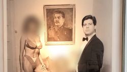 David Geovanis, a Moscow-based American businessman and former associate of US President Donald Trump, appears in a portrait titled 'The Capitalist' with three unnamed women in front a picture of Josef Stalin. The women's faces have been blurred by CNN to protect their identity.