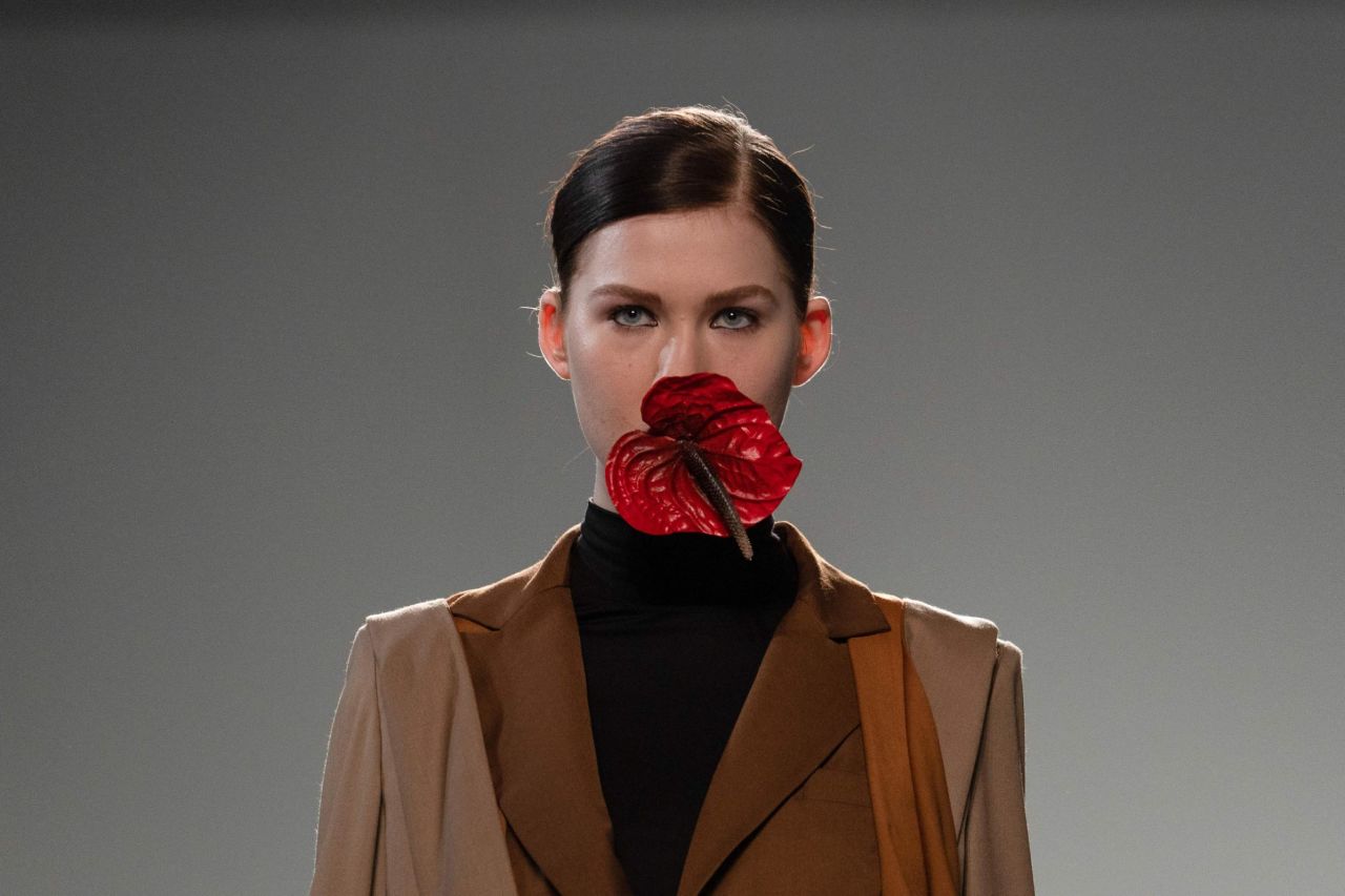Models at Marta Jakubowski's show carried Anthurium flowers in their mouths.