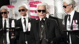 German fashion designer and photographer Karl Lagerfeld poses with models during the launch party of Coke diet (Coca Cola Light) in Paris on April 7, 2011. AFP PHOTO BERTRAND LANGLOIS (Photo credit should read BERTRAND LANGLOIS/AFP/Getty Images)