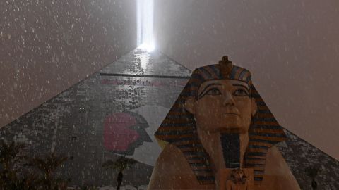 The light on top of the Luxor Hotel and Casino in Las Vegas illuminates snow falling during a winter storm on Wednesday.