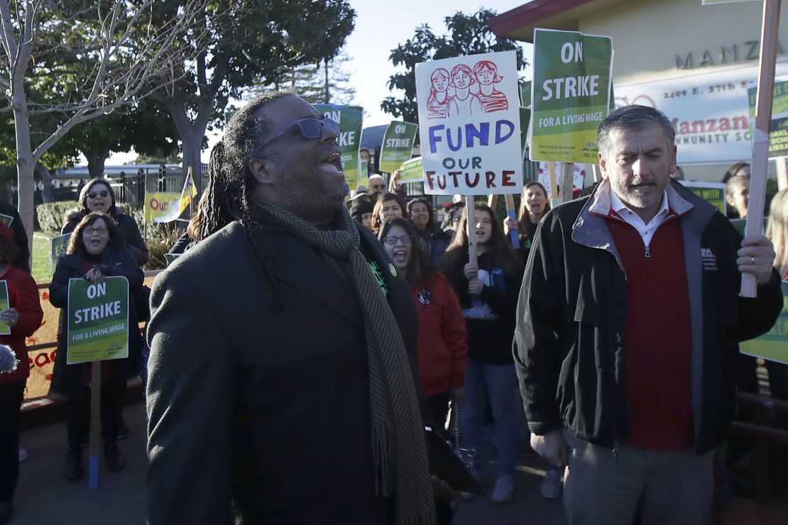 Teachers' union president Keith Brown yells after speaking outside of a school in Oakland on February 21. 
