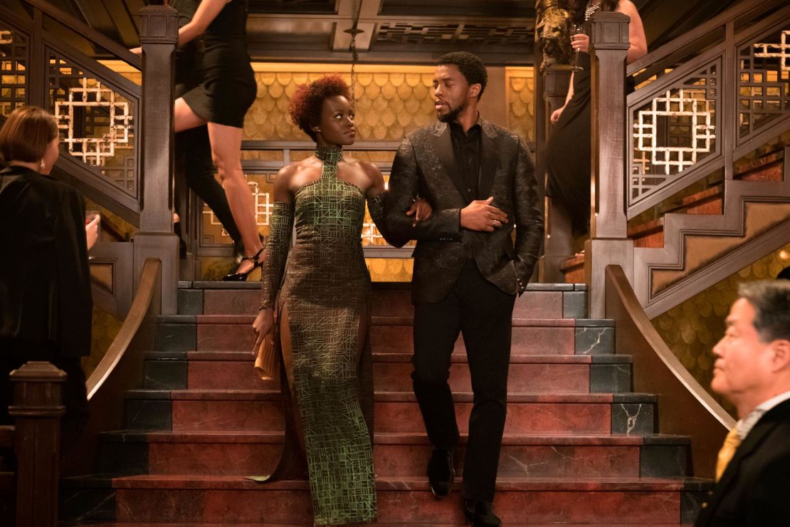 Nakia (Lupita Nyong'o) -- here with  the Black Panther himself (Chadwick Boseman) -- wears a kente cloth-inspired dress covered in Wakandan text.