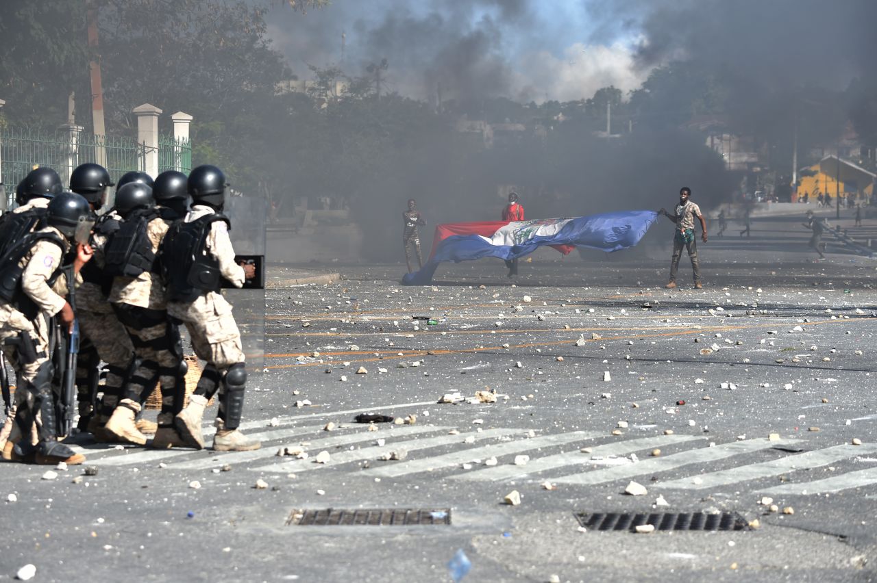 Police try to break up a protest in front of the National Palace in Port-au-Prince on February 13.