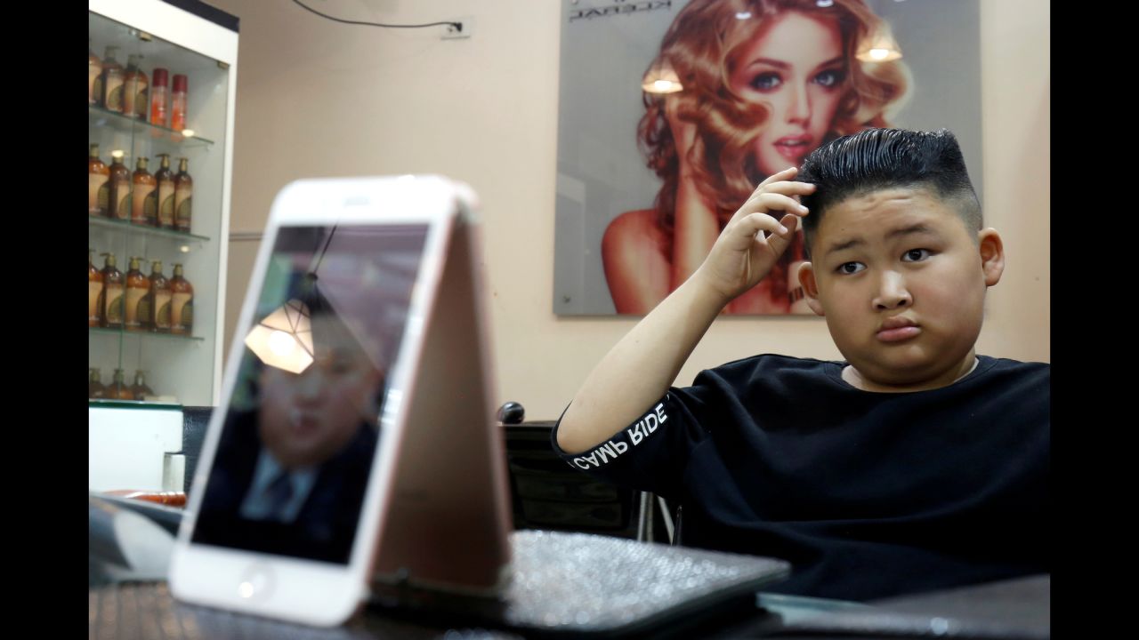To Gia Huy, 9, checks out his new haircut at a salon in Hanoi, Vietnam, on Tuesday, February 19. It's the hairstyle of North Korean leader Kim Jong Un, who will be visiting Hanoi next week <a href="https://www.cnn.com/2019/02/21/politics/trump-kim-summit-meeting/index.html" target="_blank">to meet with US President Donald Trump.</a> In honor of the summit, a Hanoi barber <a href="https://www.reuters.com/article/us-northkorea-usa-haircut/hair-force-un-vietnamese-barber-marks-summit-with-free-trump-kim-haircuts-idUSKCN1Q81G5" target="_blank" target="_blank">is offering free haircuts</a> to people who want their hair to look like Kim's or Trump's.