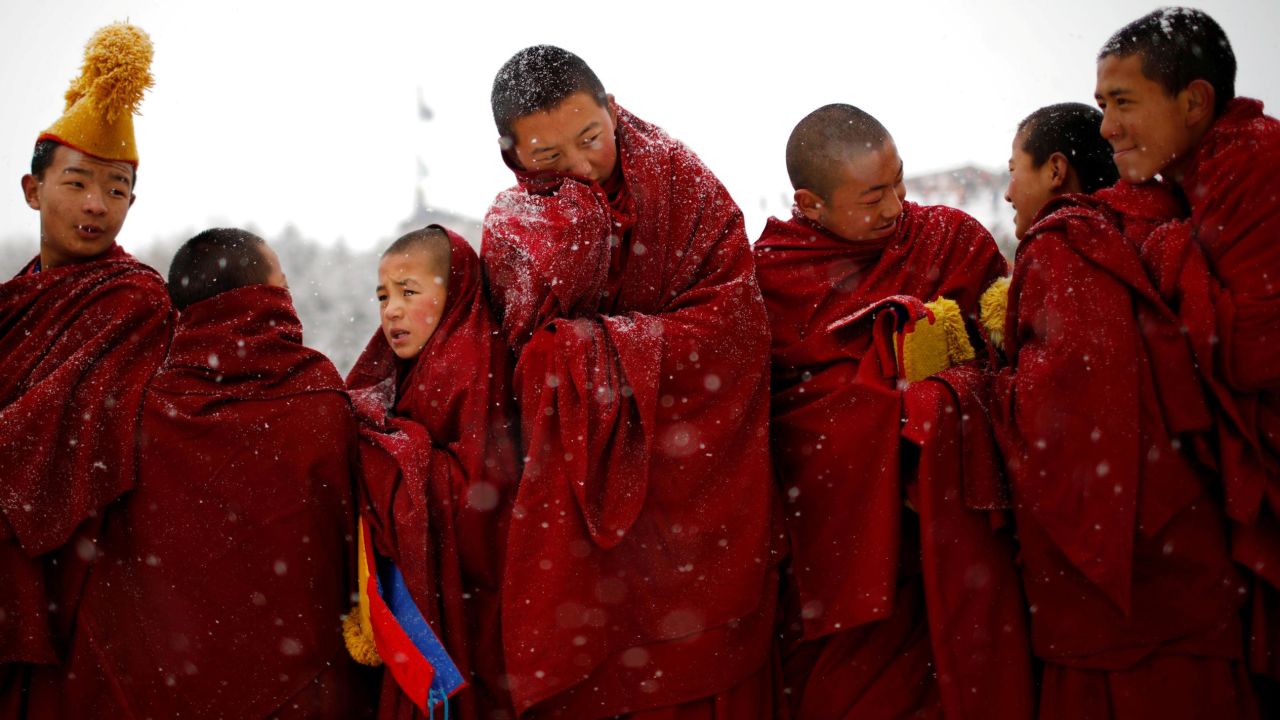 Tibetan monks attend a ceremony Sunday, February 17, during the Sunbathing Buddha Festival in China's Gannan Tibetan Autonomous Prefecture.