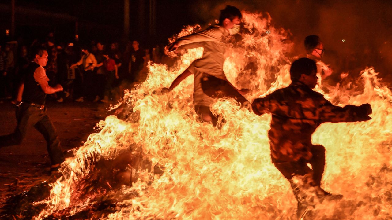 People in Haikou, China, jump over a bonfire Tuesday, February 19, during the Lantern Festival, which marks the end of Lunar New Year celebrations.