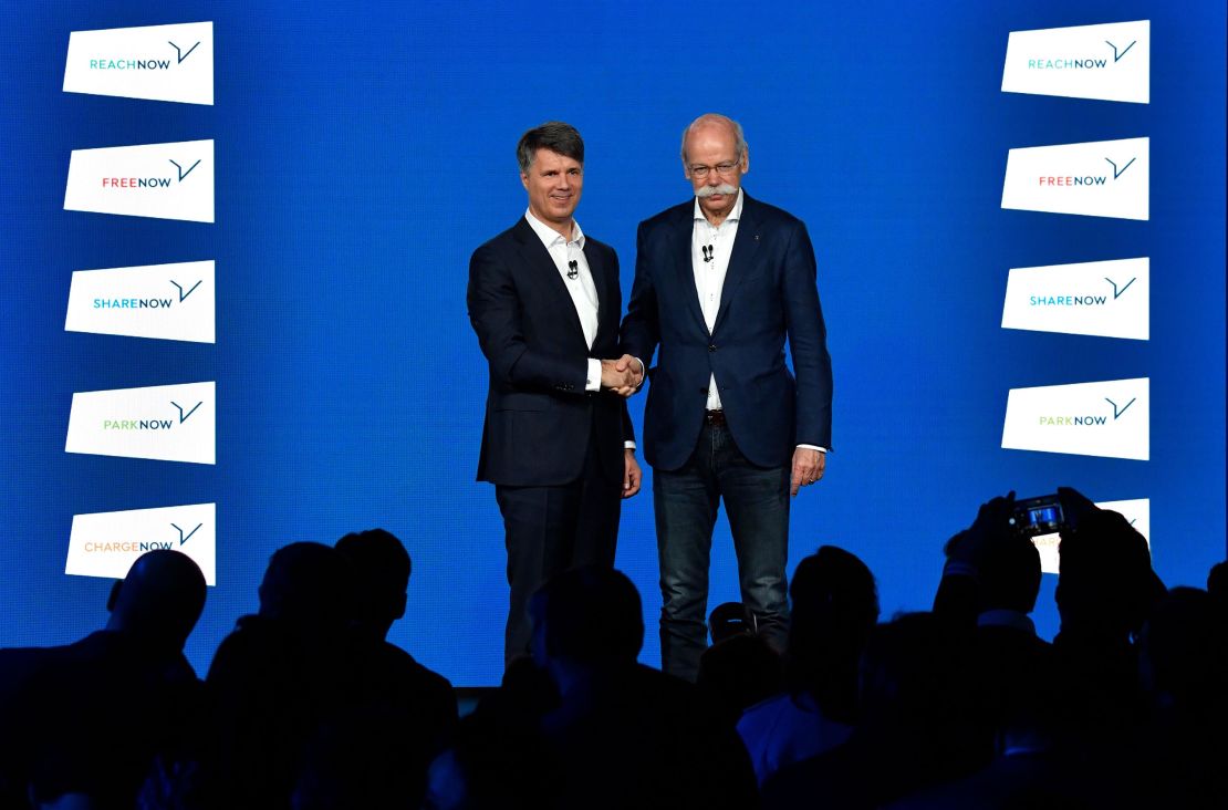 BMW CEO Harald Krueger shakes hands last week with Daimler CEO Dieter Zetsche.