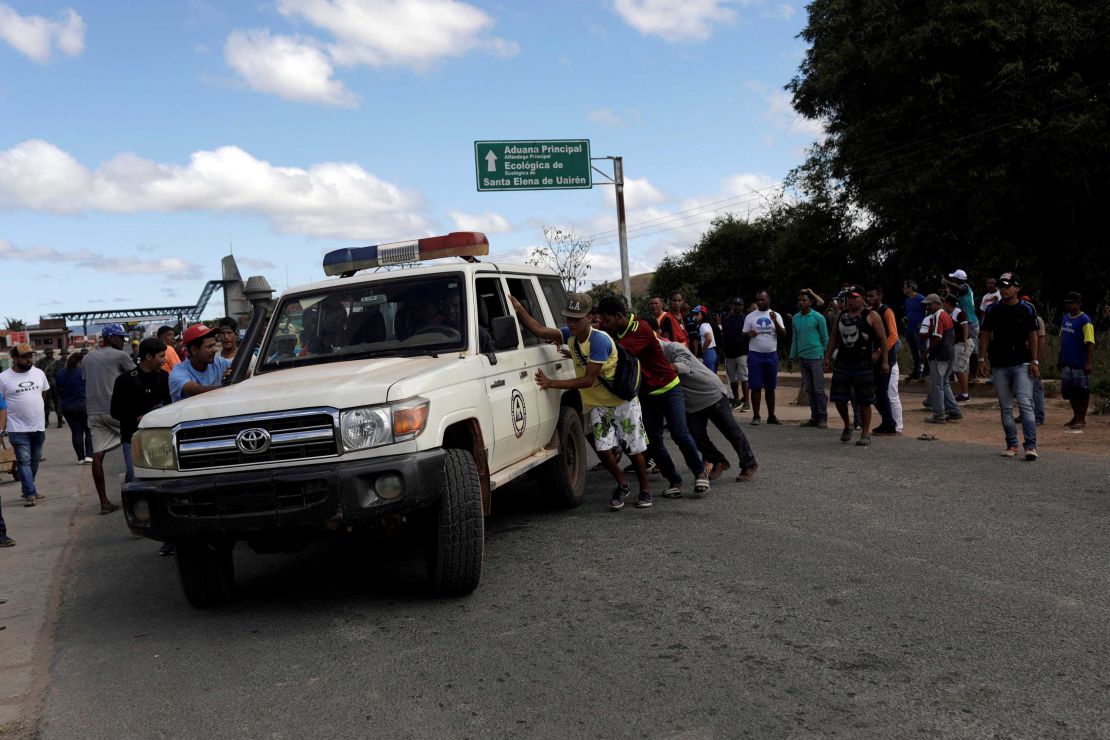 An ambulance carries people injured in clashes Friday in southern Venezuela near the Brazilian border.