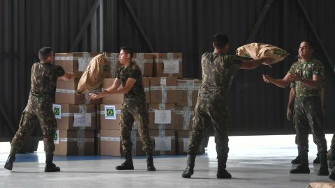 Brazilian soldiers organize sacks of powdered milk Friday in Boa Vista in humanitarian aid for Venezuela.