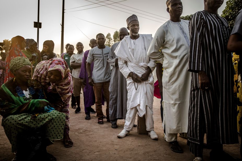 People line up to vote in the presidential election a few hours before polls open at Shagari Health Unit polling station in Yola.