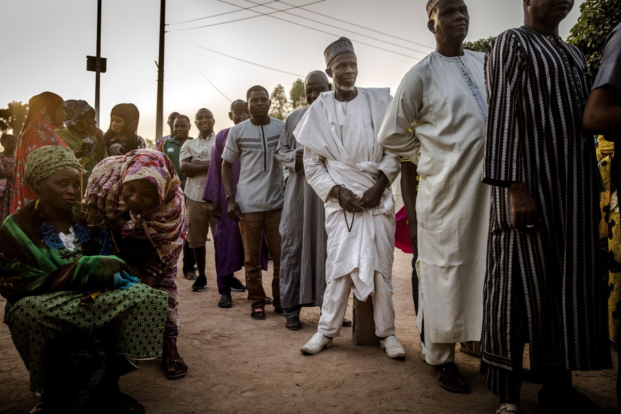 People line up to vote in the presidential election a few hours before polls open at Shagari Health Unit polling station in Yola.