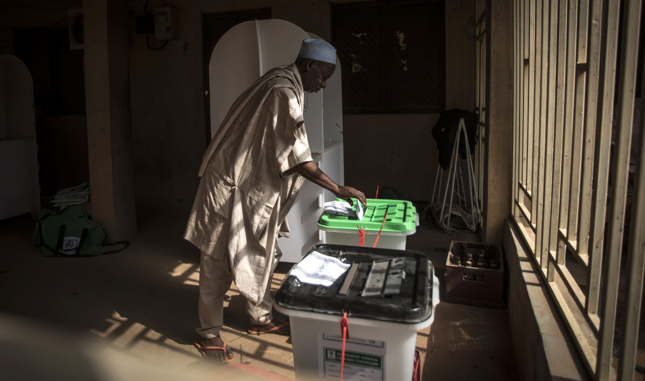 One of the first voters casts his ballots for presidential and parliamentary seats on Saturday, February 23, at the Unguwar Sarki polling station in Kaduna, Nigeria.
