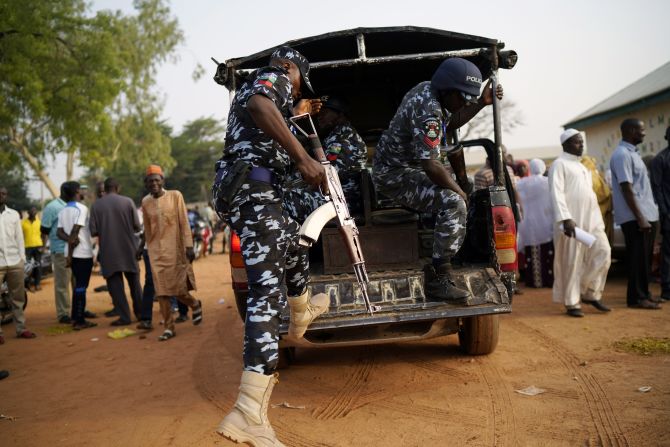 Nigerian police arrive at a polling station in Kaduna.