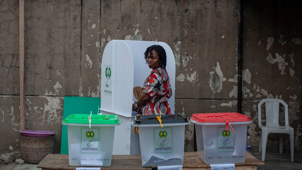 A woman glances over at the ballot boxes one last time before casting her vote Saturday in Lagos.