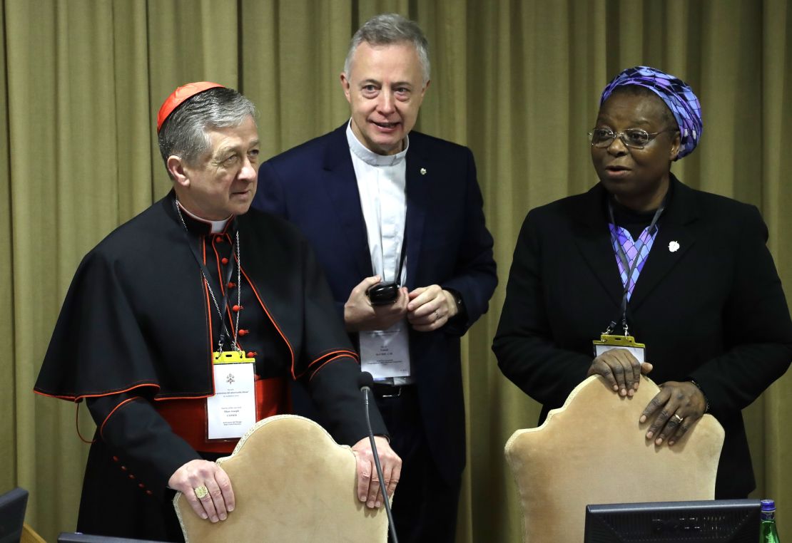 Sister Veronica Openibo stands next to Chicago Archbishop Cardinal Blase J. Cupich, left, and Father Tomaz Mavric as they wait for the Pope's arrival at the beginning of the third day of a Vatican's conference on clergy sex abuse.