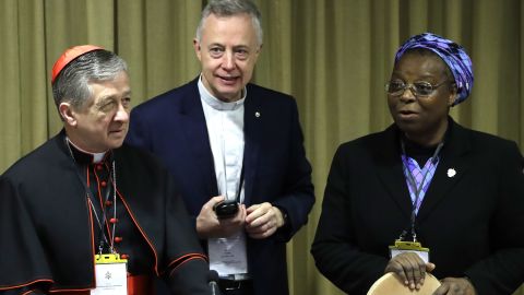Sister Veronica Openibo stands next to Chicago Archbishop Cardinal Blase J. Cupich, left, and Father Tomaz Mavric as they wait for the Pope's arrival at the beginning of the third day of a Vatican's conference on clergy sex abuse. 
