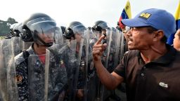 Venezuelans confront national policemen demanding them to let the humanitarian aid in, at the Simon Bolivar bridge, in Cucuta, Colombia after President Nicolas Maduro's government ordered to temporary close down the border with Colombia on February 23, 2019. - Venezuela braced for a showdown between the military and regime opponents at the Colombian border on Saturday, when self-declared acting president Juan Guaido has vowed humanitarian aid would enter his country despite a blockade. (Photo by Luis ROBAYO / AFP)        (Photo credit should read LUIS ROBAYO/AFP/Getty Images)