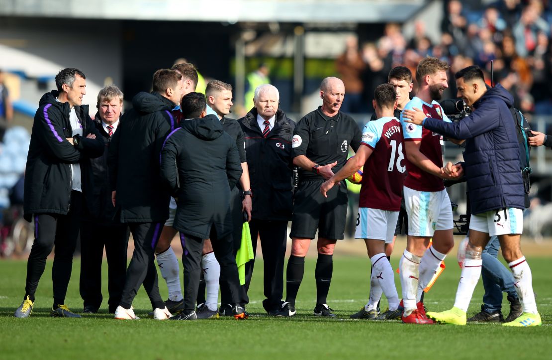 Tottenham manager Mauricio Pochettino (second from left) was upset with referee Mike Dean (second from right) after his team lost at Burnley. 