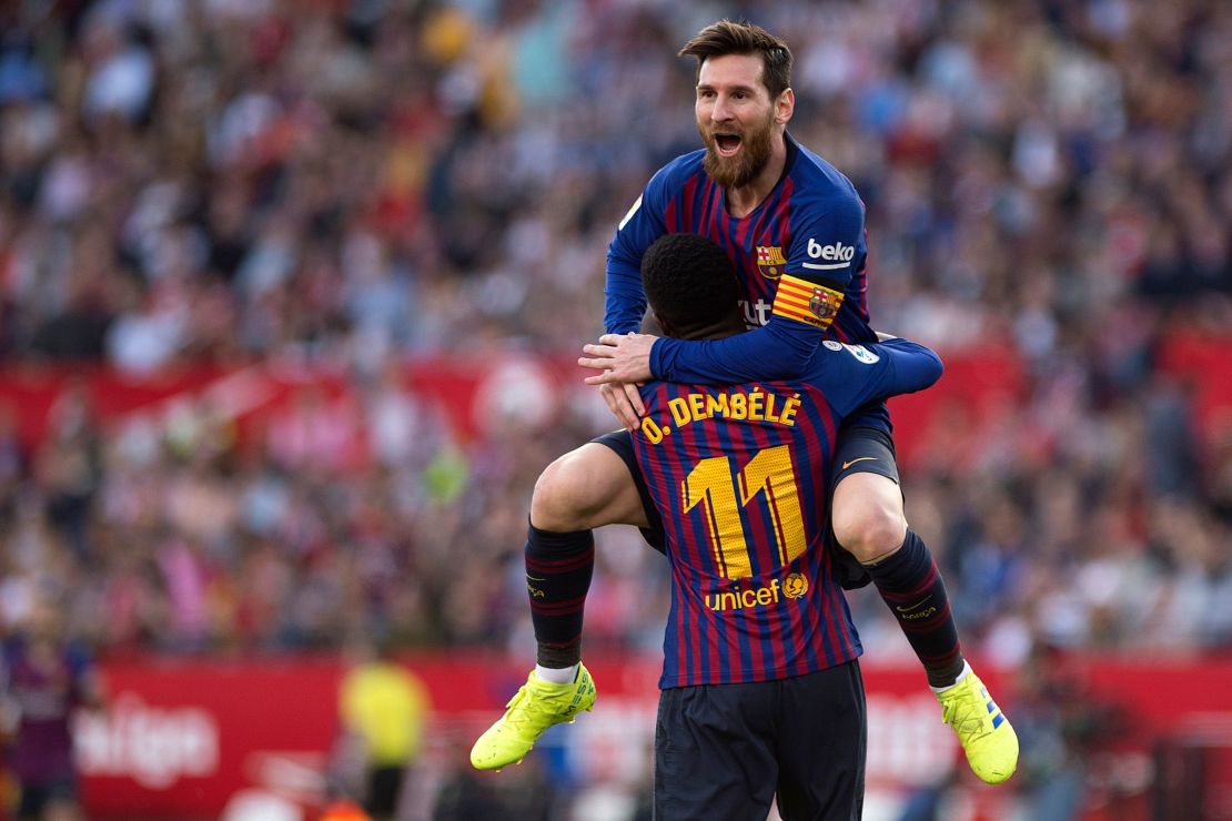 Lionel Messi celebrates with teammate Ousmane Dembele after scoring against Sevilla. 