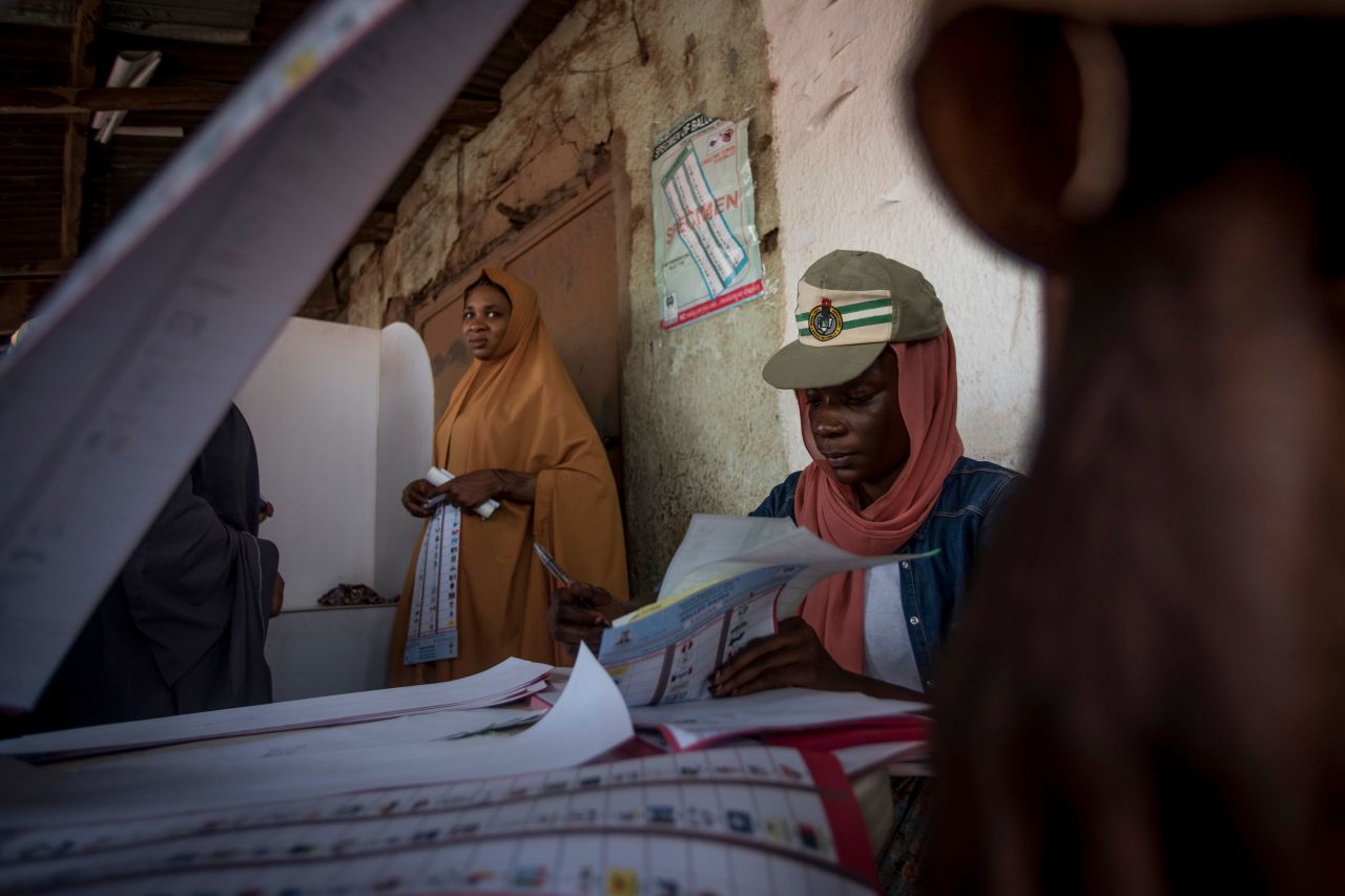 A polling station worker checks and counts ballot papers at Badarawa Junction polling station in Kaduna.