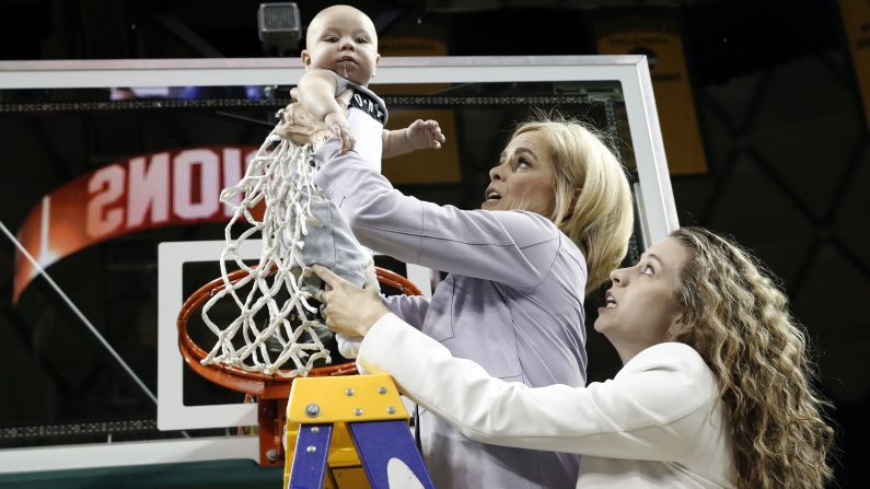 Baylor basketball coach Kim Mulkey holds up her grandson Kannon Reid Fuller as she and her daughter Makenzie Fuller cut down the nets following a game against Kansas on Wednesday, February 20. The women's basketball team had just won the Big 12 regular-season title for the ninth consecutive year.