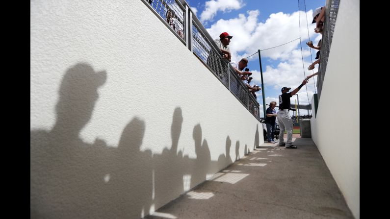 New York Yankees infielder Angel Aguilar signs autographs for fans before a spring-training game against Boston on Saturday, February 23.