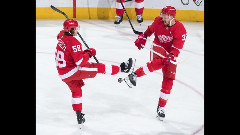 Detroit's Tyler Bertuzzi, left, and Anthony Mantha juggle the puck while warming up for an NHL game against Minnesota on Friday, February 22.