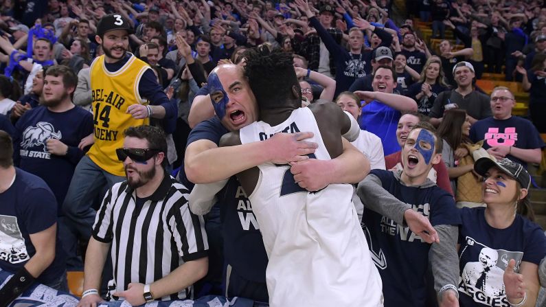 Utah State center Neemias Queta celebrates with a fan after a home win over New Mexico on Wednesday, February 20.