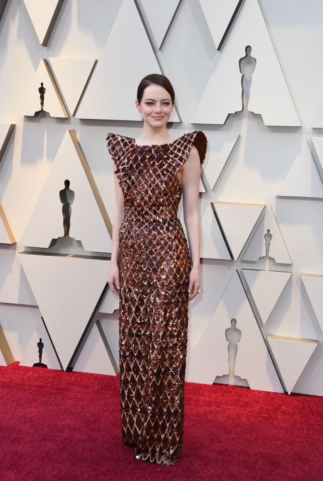 Emma Stone Arrives in the Shiniest Louis Vuitton Jumpsuit to the