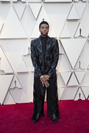 Award presenter Chadwick Boseman was one of the few men who didn't play it safe, wearing a textured black and blue floor length jacket by Givenchy. The "Black Panther" star consistently wears patterned blazers to red carpet events. 