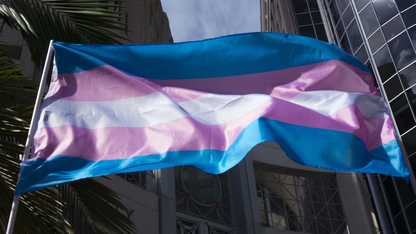 A transgender flag is seen waving during the We Wont Be Erased transgender rights movement during a gathering at City Hall in Orlando, Florida on Saturday, October 27, 2018. (Alex Menendez via AP)